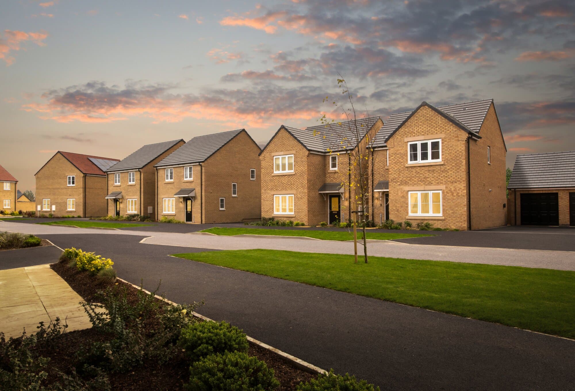 A street of completed Allison Homes houses at dusk, showing the quality and character of finished homes